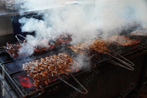 Fresh seafood such as prawns, fish, octopus, oysters grilled over charcoal or embers. This dish will be served for dinner on the beach photo