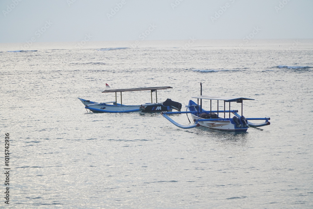 Fisherman boat on the coast of Kuta Bali beach with cloudy sky Fisherman boat on the coast of Kuta Bali beach with cloudy sky