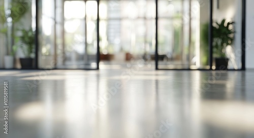 Blurred background of a modern office interior featuring glass windows and a polished floor, with a focus on the hallway