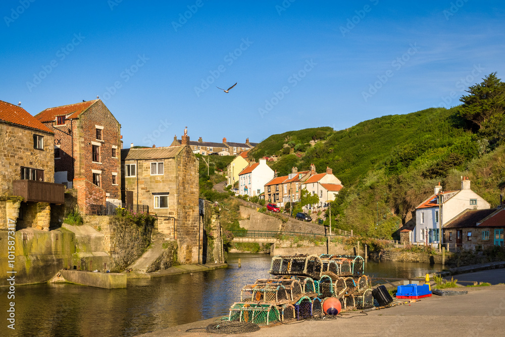 Fototapeta premium Staithes, North Yorkshire, UK - Old fishing village of Staithes, at high tide on a summer morning.
