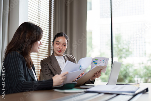 Professional Team Analyzing Reports During Corporate Meeting photo