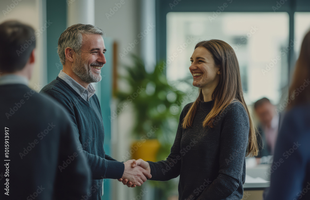 Business professionals meet for the first time at a conference, exchanging smiles and handshakes as they introduce themselves. The environment is welcoming and conducive to networking. Business professionals meet for the first time at a conference, exchanging smiles and handshakes as they introduce themselves. The environment is welcoming and conducive to networking.