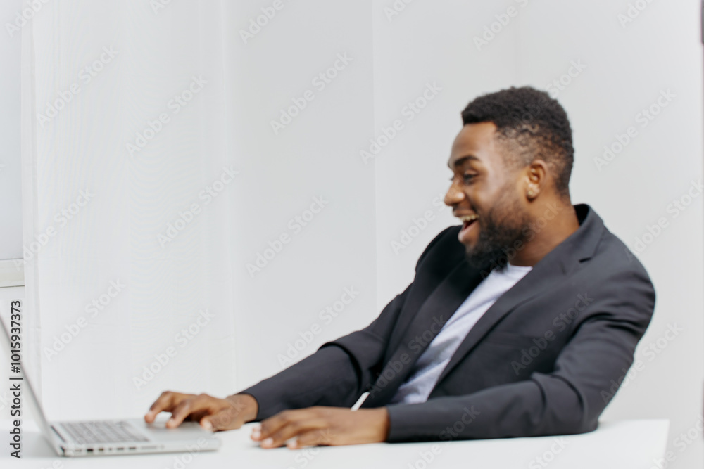 Business professional in suit working on laptop at office desk concentrated on important project or task Business professional in suit working on laptop at office desk concentrated on important project or task