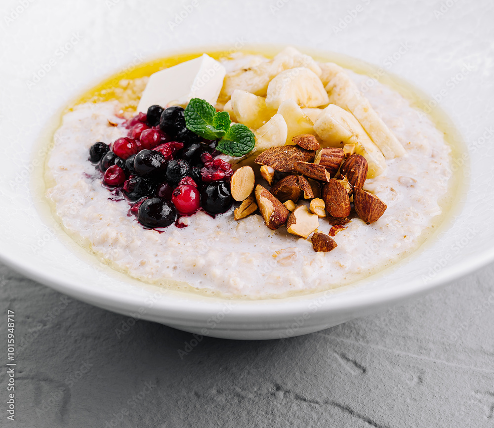 Oatmeal porridge with berries, banana and almonds for healthy breakfast Oatmeal porridge with berries, banana and almonds for healthy breakfast