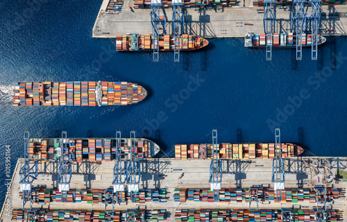 Fototapet Aerial top down view of a large container cargo ship terminal harbor with loadin