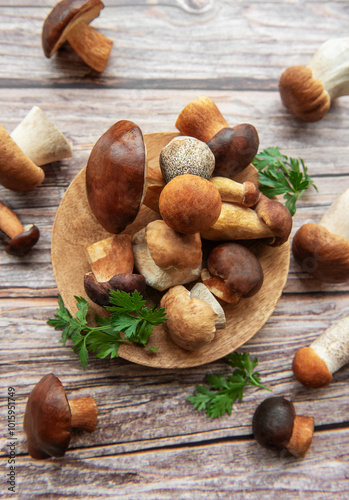 Assorted fresh mushrooms and herbs arranged on a wooden board in a rustic kitchen setting