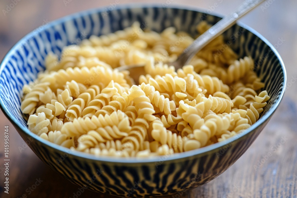 A bowl of pasta with a spoon in it