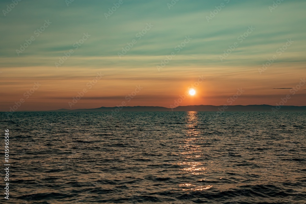 Fototapeta premium Fantastic sunset sun over Lake Baikal, summer time. Russia, Lake Baikal, Olkhon Island.