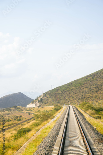 A view of a railway line passing through the countryside.