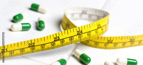 Weight loss pills and measure tape ruler isolated on a white background. Concept of illness, pain, care, painkiller, pharmacy, healthcare, supplements. Copy space for text.  photo