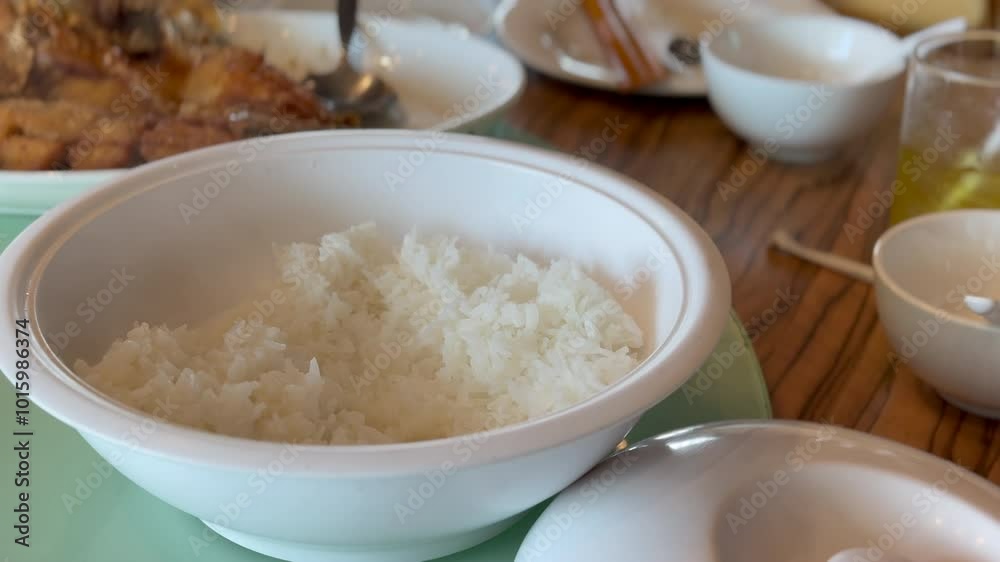 The Asian family have lunch together in the Thai restaurant. The Asian family have lunch together in the Thai restaurant.