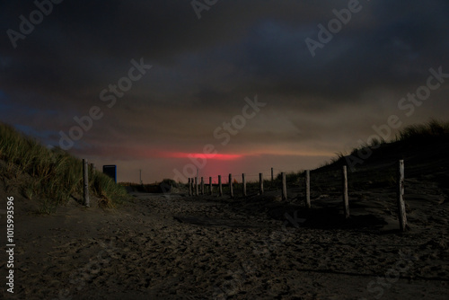 Dunes on the beach near the Pettendorf Monument in the Netherlands at night with a full moon photo