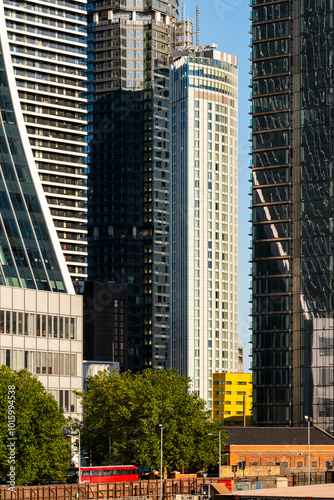 A striking view of a bustling city skyline, featuring iconic tall buildings and a vibrant blue sky, capturing the dynamic essence of urban life and architectural innovation in London UK photo