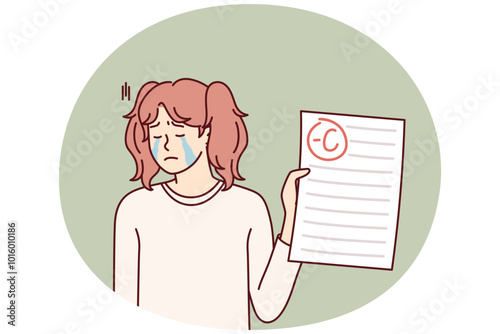 Crying teenage girl depressed because of negative mark on test or exam paper. Unhappy schoolgirl is sad after receiving bad grade from teacher for extracurricular work and needs help of tutor