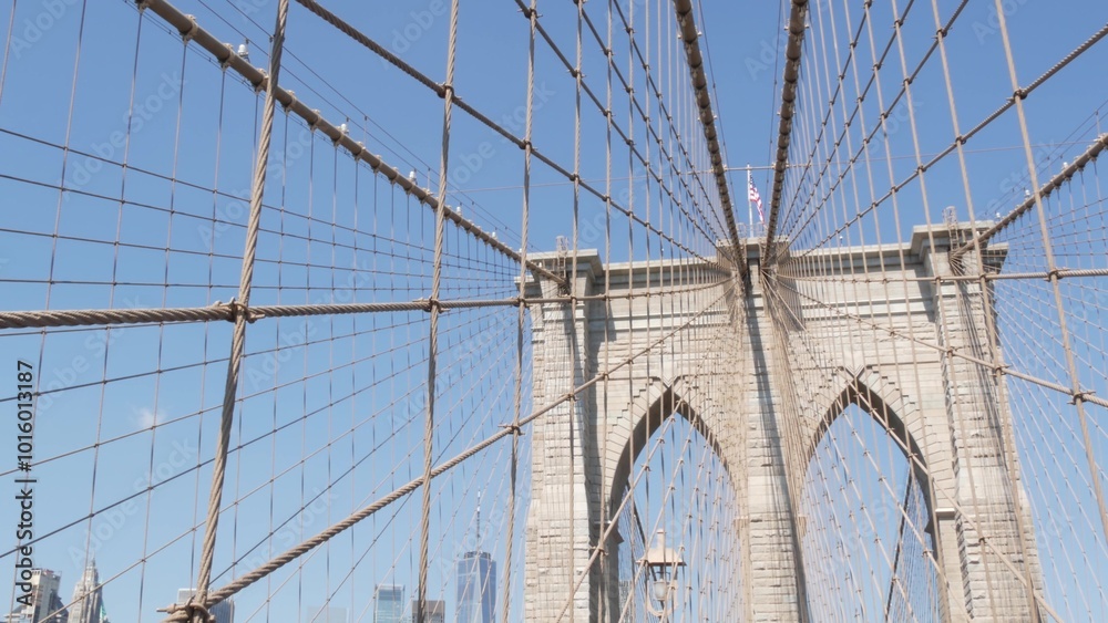 Obraz premium Brooklyn Bridge to Manhattan downtown, cables and blue sky. New York City iconic symbol, USA travel destination. Architecture of United States of America, tourist landmark. Famous cable-stayed bridge.