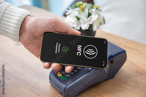 Man hand phone pay wireless technology nfc via pos terminal