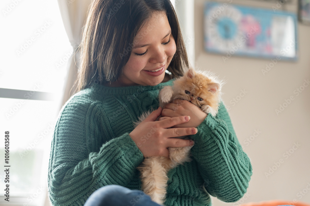 Young latina woman with baby cat in bedroom Young latina woman with baby cat in bedroom