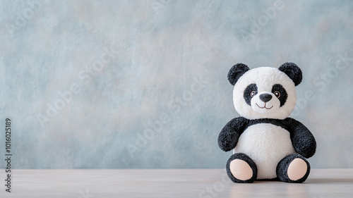 Cute panda stuffed toy with soft fur placed on neutral background, evoking sense of warmth and comfort. Perfect for children and collectors alike photo