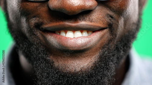 Man's mouth, close-up, on a green background