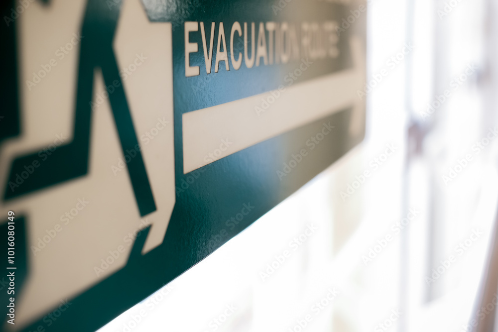 Evacuation route direction signage placed in public transport station Evacuation route direction signage placed in public transport station