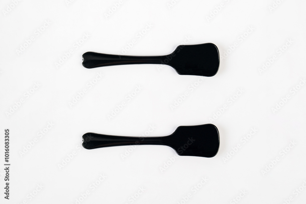 Black ice cream spoon on white background Black ice cream spoon on white background