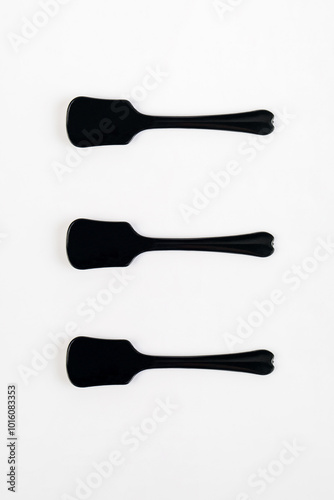 Black ice cream spoon on white background