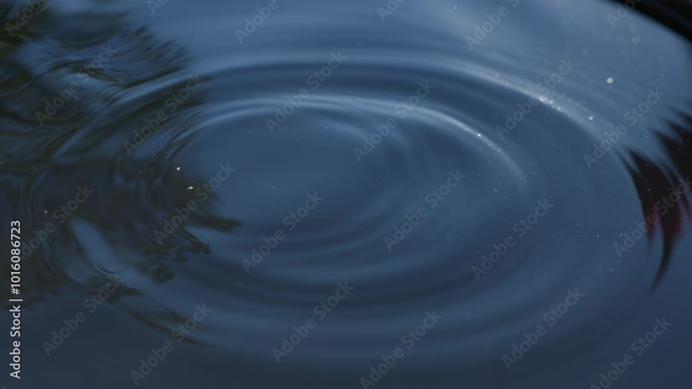 water droplet impact with circle waves on water surface slow motion