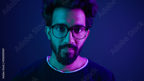 Close up portrait Arabian Indian man guy male programmer coder put on glasses 3d dimension focus gesture insight good eye sight vision focused view eyesight computer work in violet neon background