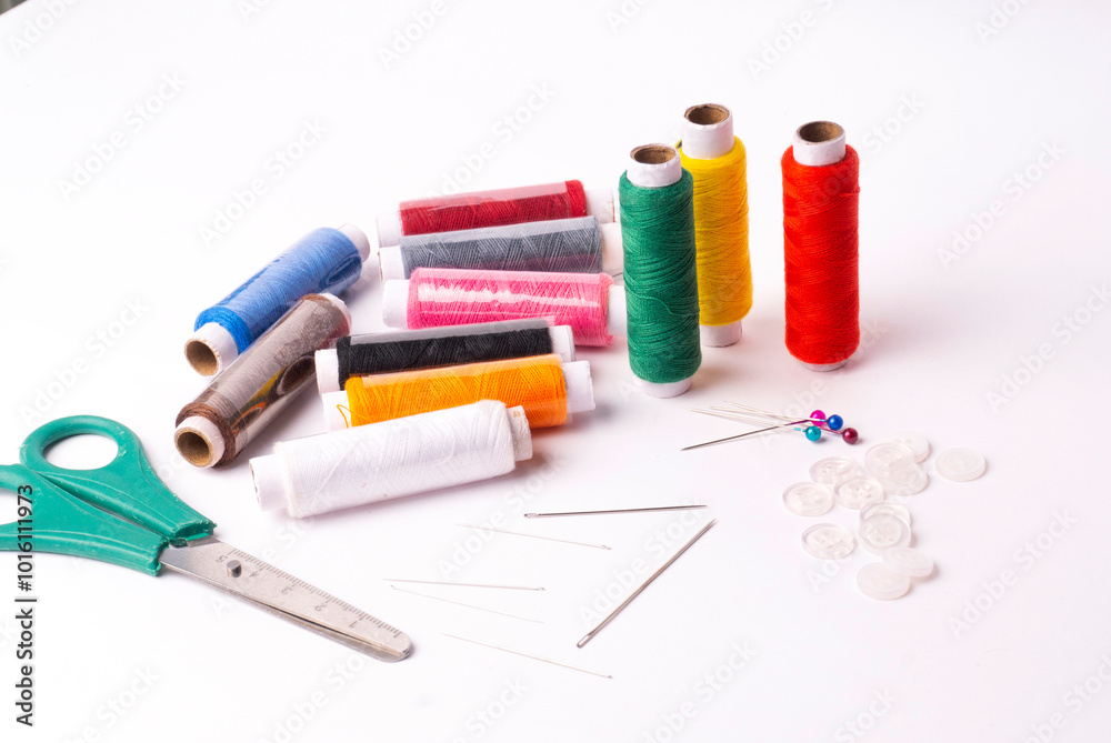 Colorful sewing thread set and needles isolated on background. Colorful sewing thread set and needles isolated on background.