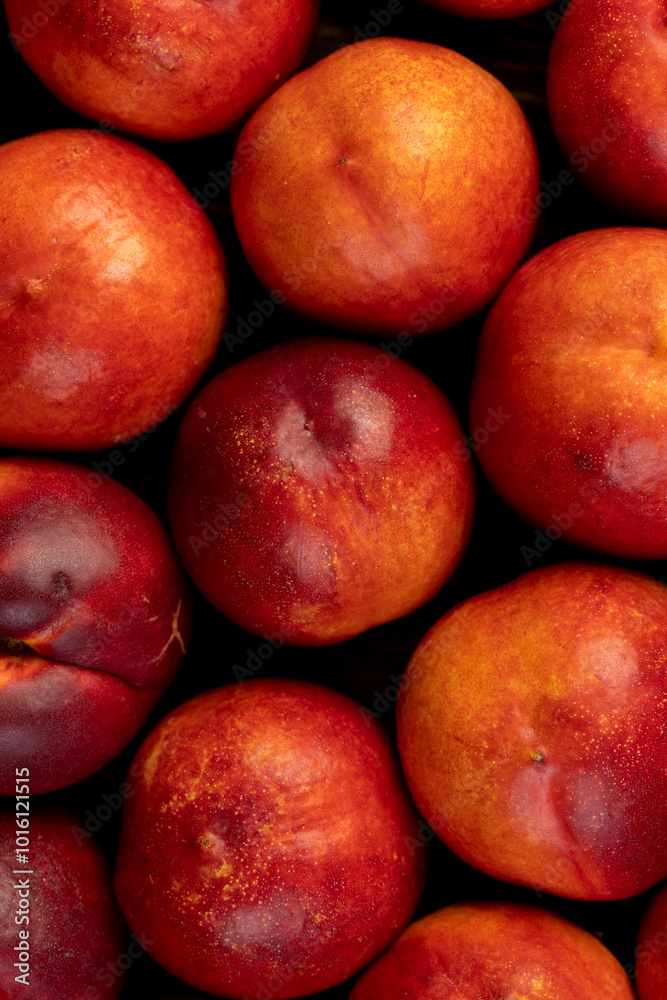 a large number of ripe soft nectarine fruits on the table a large number of ripe soft nectarine fruits on the table