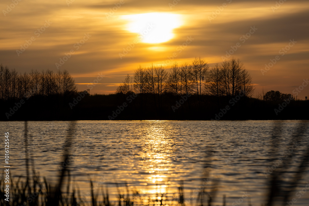 orange sunset is reflected in the water of the lake orange sunset is reflected in the water of the lake