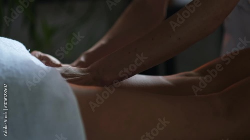 Caucasian young woman lying on massage table enjoying and relax. Female hands masseuse massaging legs of client in calm atmosphere with candles. Spa center. Healthy body care Therapeutic concept. 4K