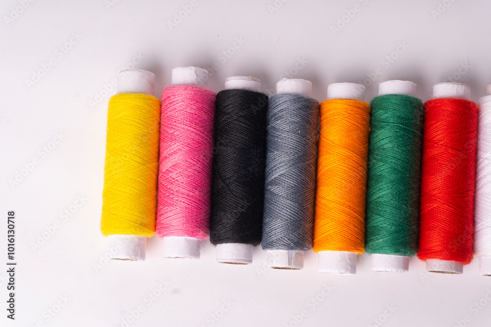 Colorful sewing thread set and needles isolated on background. Colorful sewing thread set and needles isolated on background.