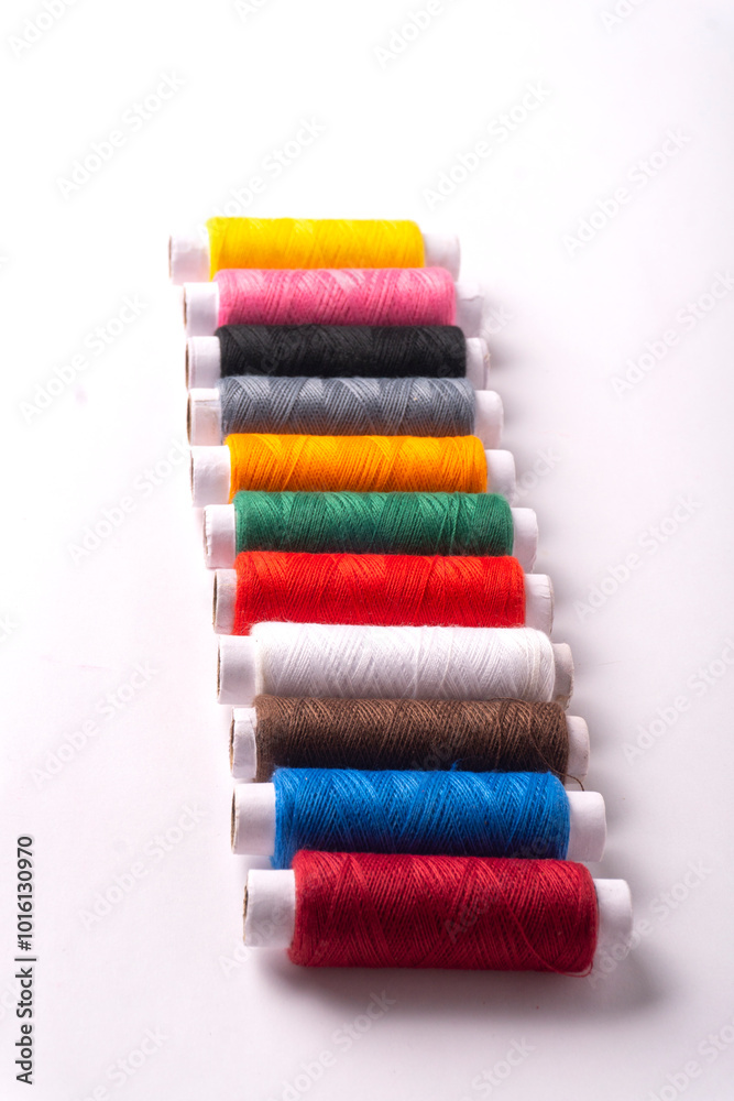 Colorful sewing thread set and needles isolated on background. Colorful sewing thread set and needles isolated on background.