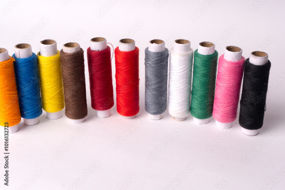 Colorful sewing thread set and needles isolated on background. Colorful sewing thread set and needles isolated on background.