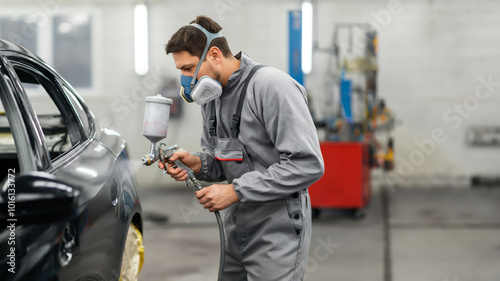 Workers painting cars