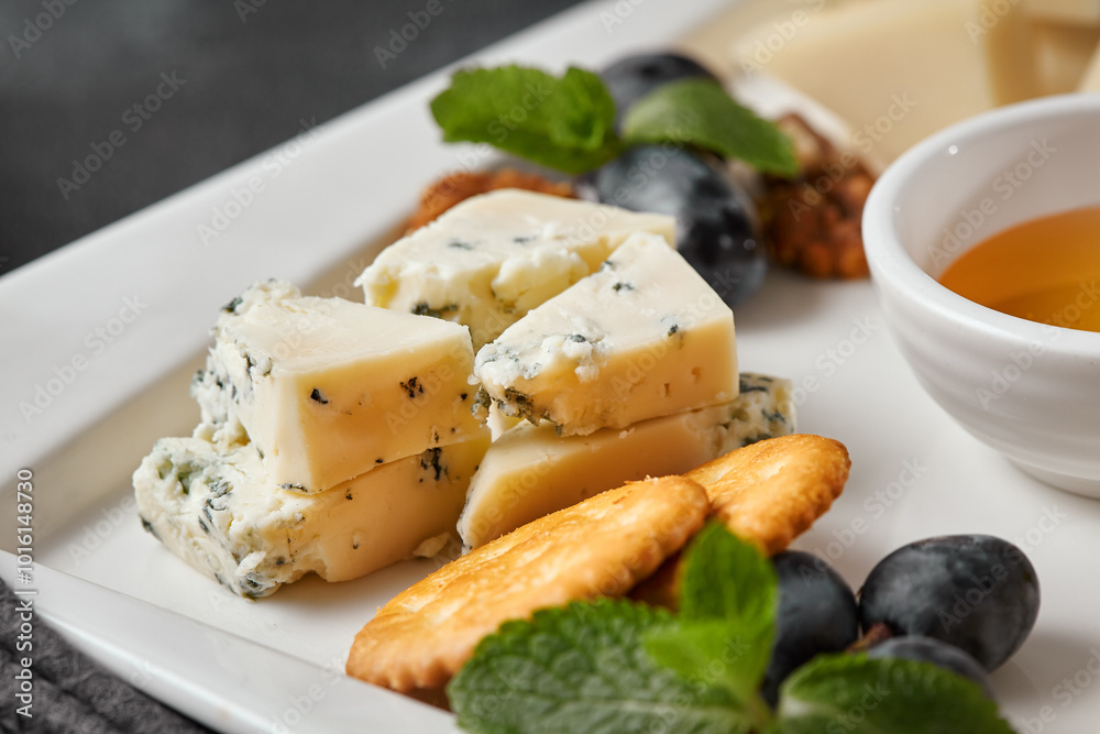 Gourmet Cheese Platter with Crackers and Grapes - Close-Up, Natural Lighting, High Contrast Gourmet Cheese Platter with Crackers and Grapes - Close-Up, Natural Lighting, High Contrast