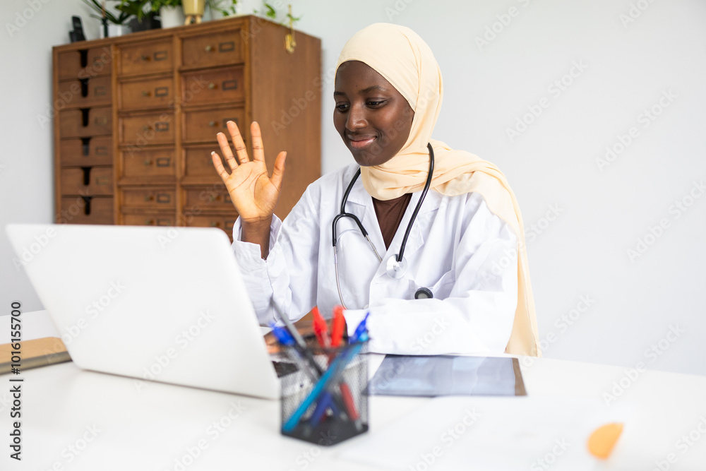 Black female doctor in hijab engaging in a video call Black female doctor in hijab engaging in a video call