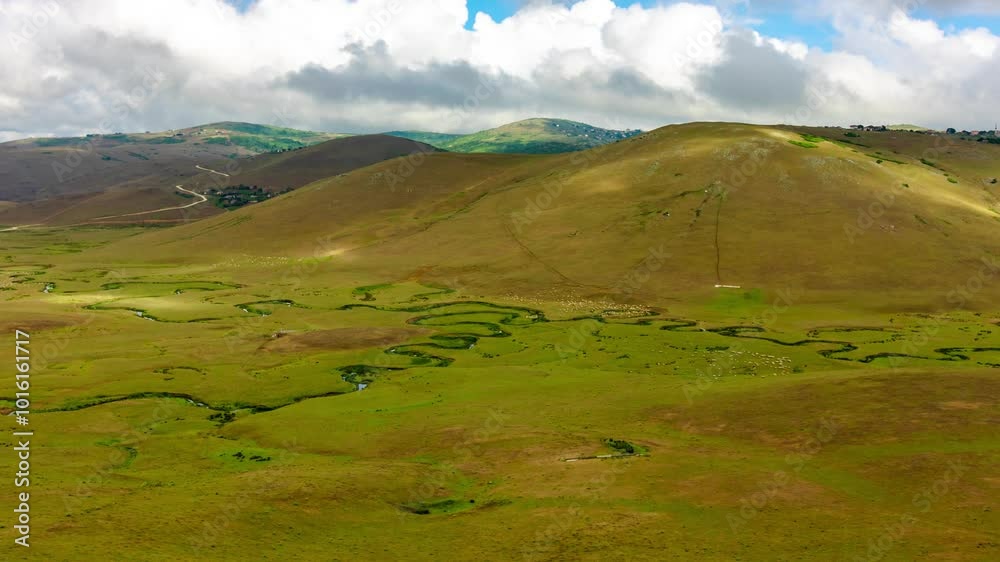Landscape timelapse. Moving clouds over the hills and meandering stream and flock of sheep. Persembe Plateau or Persembe Yaylasi in Aybasti district of Ordu in Turkey. Landscape timelapse. Moving clouds over the hills and meandering stream and flock of sheep. Persembe Plateau or Persembe Yaylasi in Aybasti district of Ordu in Turkey.