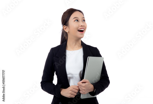 Portrait young asian businesswoman in suit celebrating success while holding a laptop isolated white background, business woman holding notebook expression with achievement and winning.