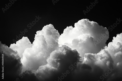 A dramatic cloudscape featuring towering clouds with contrasting light and dark tones, evoking a sense of awe and introspection in a majestic atmosphere.