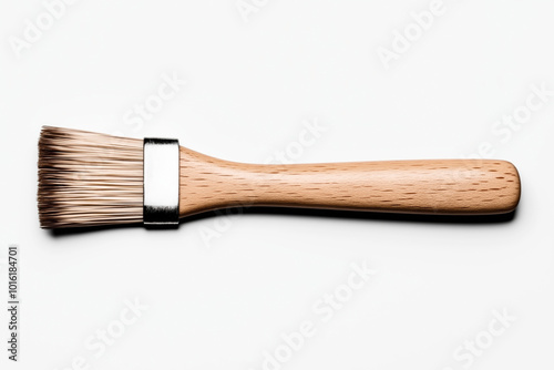 Flat wooden-handled paintbrush with natural bristles, isolated on a white background. Suitable for painting, crafts, and home improvement projects.