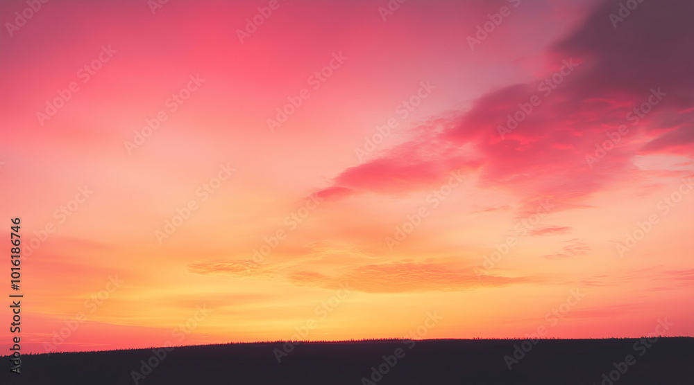 Fototapeta premium silhouette of a hill against a gradient sky that transitions from soft pink to deep orange