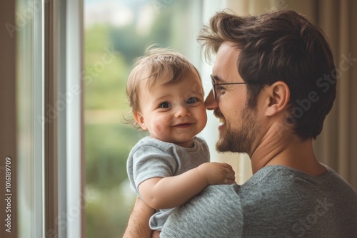 A heartwarming capture of a father holding his smiling child by a window, bathed in natural daylight, symbolizing love and familial connection.