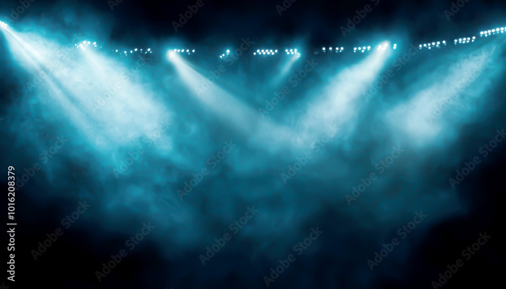 Fototapeta premium Spotlights shine through mist, creating a dramatic ambiance for performances and events. Perfect for capturing the essence of entertainment.