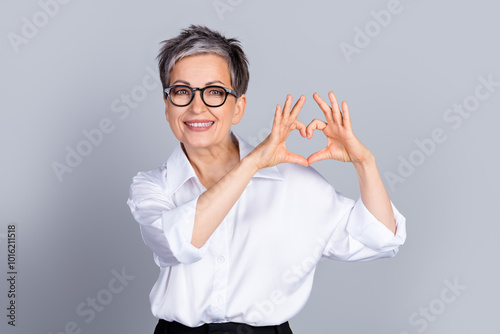 Photo of classy aged corporate woman show heart symbol wear shirt isolated on grey color background photo