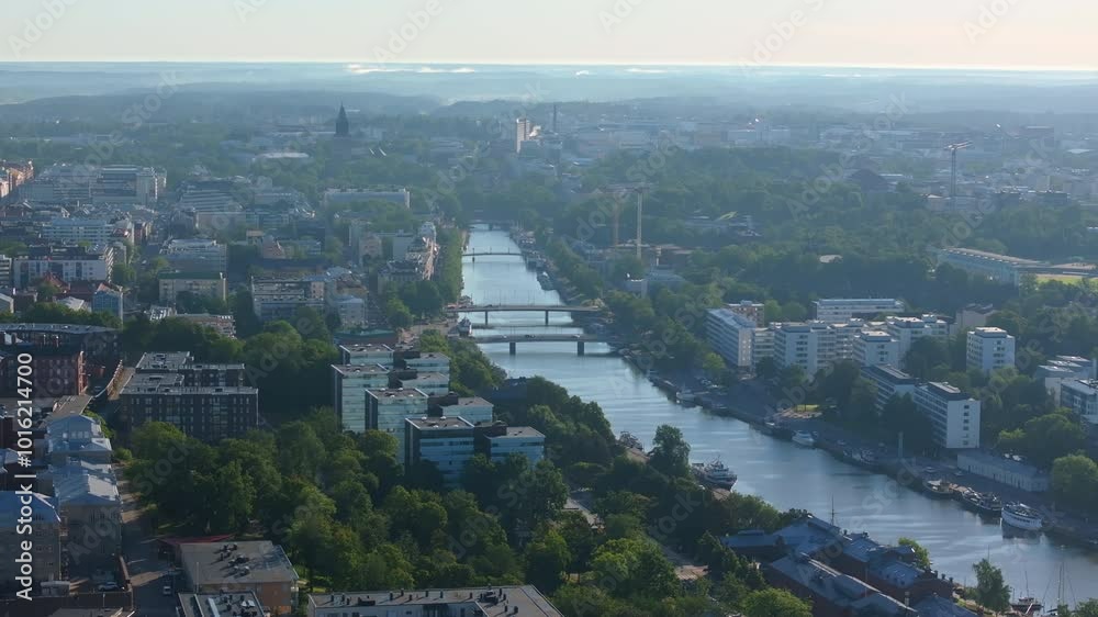 Aura River is flowing through Turku city center on a beautiful summer day. View from above to the river, bridge, buildings and parks Aura River is flowing through Turku city center on a beautiful summer day. View from above to the river, bridge, buildings and parks