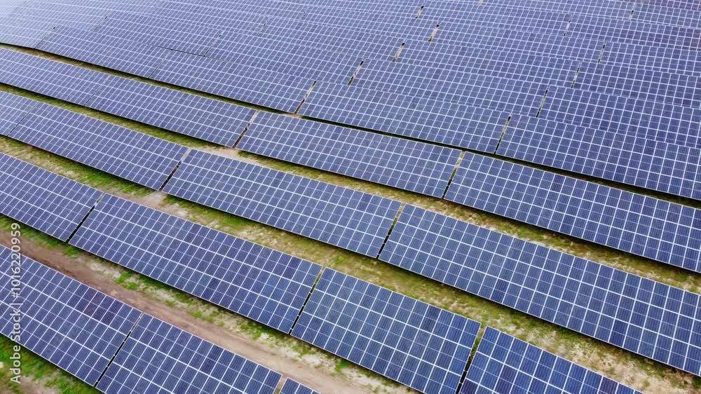 Wide Aerial Shot of Solar Panel Array Installed in Rows Across Farmland Wide Aerial Shot of Solar Panel Array Installed in Rows Across Farmland