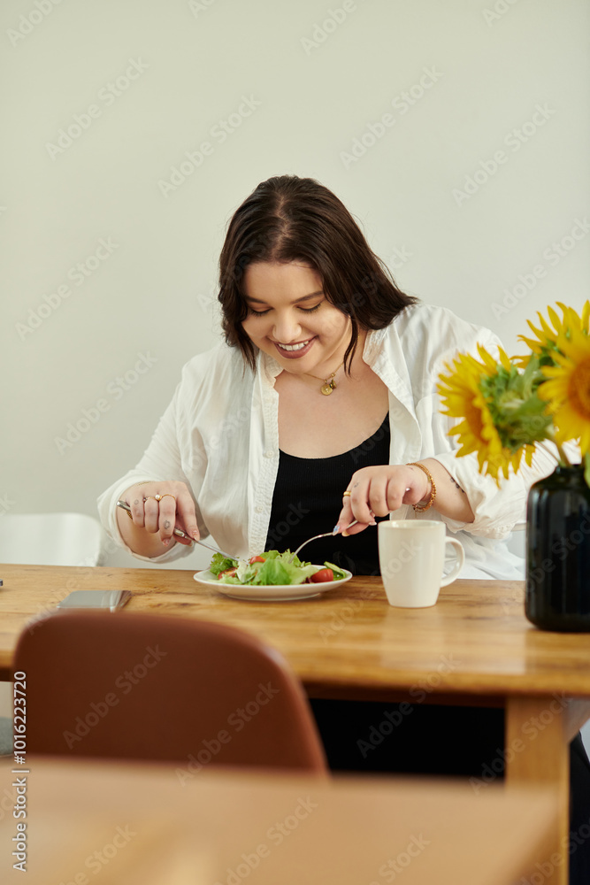 A joyful woman savoring a nutritious salad at her kitchen table. A joyful woman savoring a nutritious salad at her kitchen table.