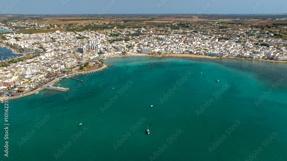 Obraz premium Aerial view Porto Cesareo, a small city on the Mediterranean Sea in the province of Lecce in Puglia, Italy. It is a tourist town located on the Ionian coast of the Salento peninsula.